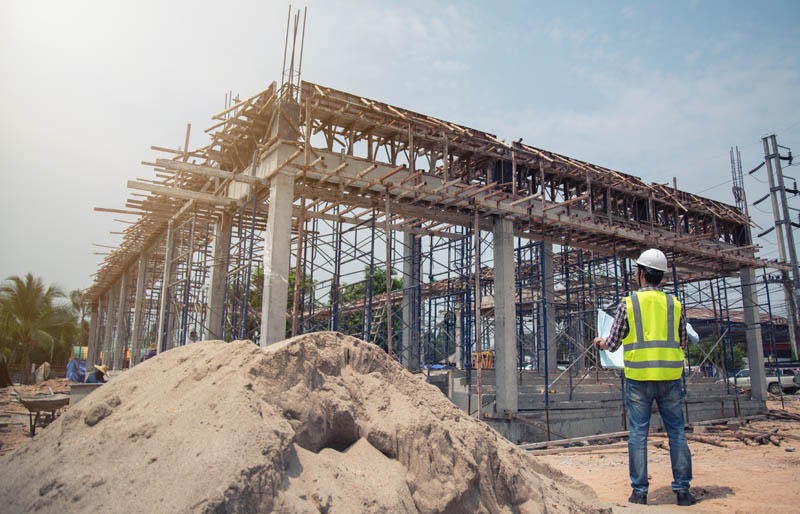 A FABCO employee inspecting a construction site to help control budgets, safeguard timelines and guarantee the quality of the finished product. 
