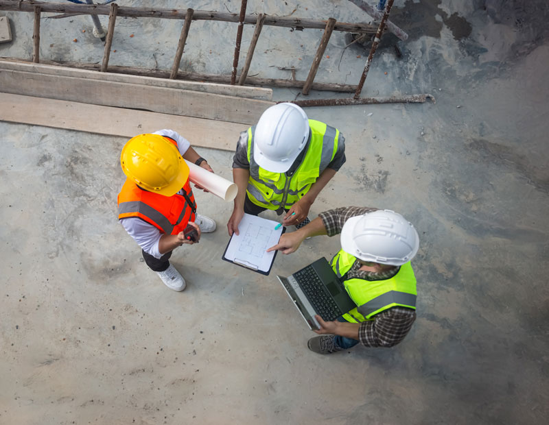 FABCO architects & engineers are discussing the progress of the building project and checking the accuracy of the building structure.
